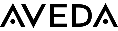 Black “AVEDA” logo in all capital letters on a light gray background, with stylized “A”s that have dots inside the lower triangle portions. - Jón Alan Salon in Nashville and Franklin, TN