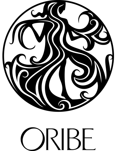 Black and white circular logo with an abstract silhouette of a woman with flowing hair and the word “ORIBE” written below. - Jón Alan Salon in Nashville and Franklin, TN